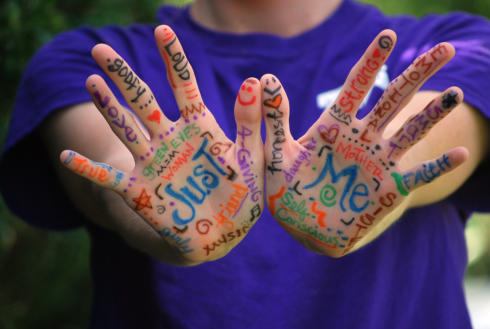 positivity - colourful writing on hands